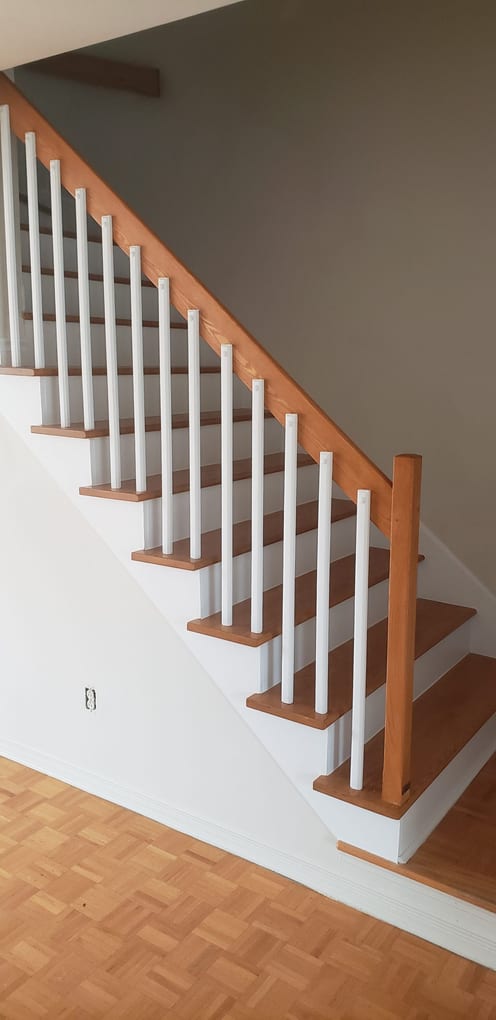 After: rebuilt staircase with oak treads, white risers and a new oak handrail